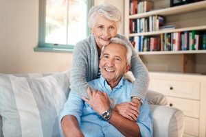 Joyful elderly couple embracing and smiling.